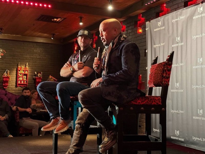 Jeremy on stage with Daymond John, fireside conversation